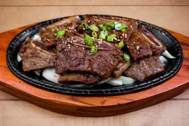 How Is Korean BBQ Different From Western-Style Grilling in Terms of Cuts, Flavor, and Dining Experience?